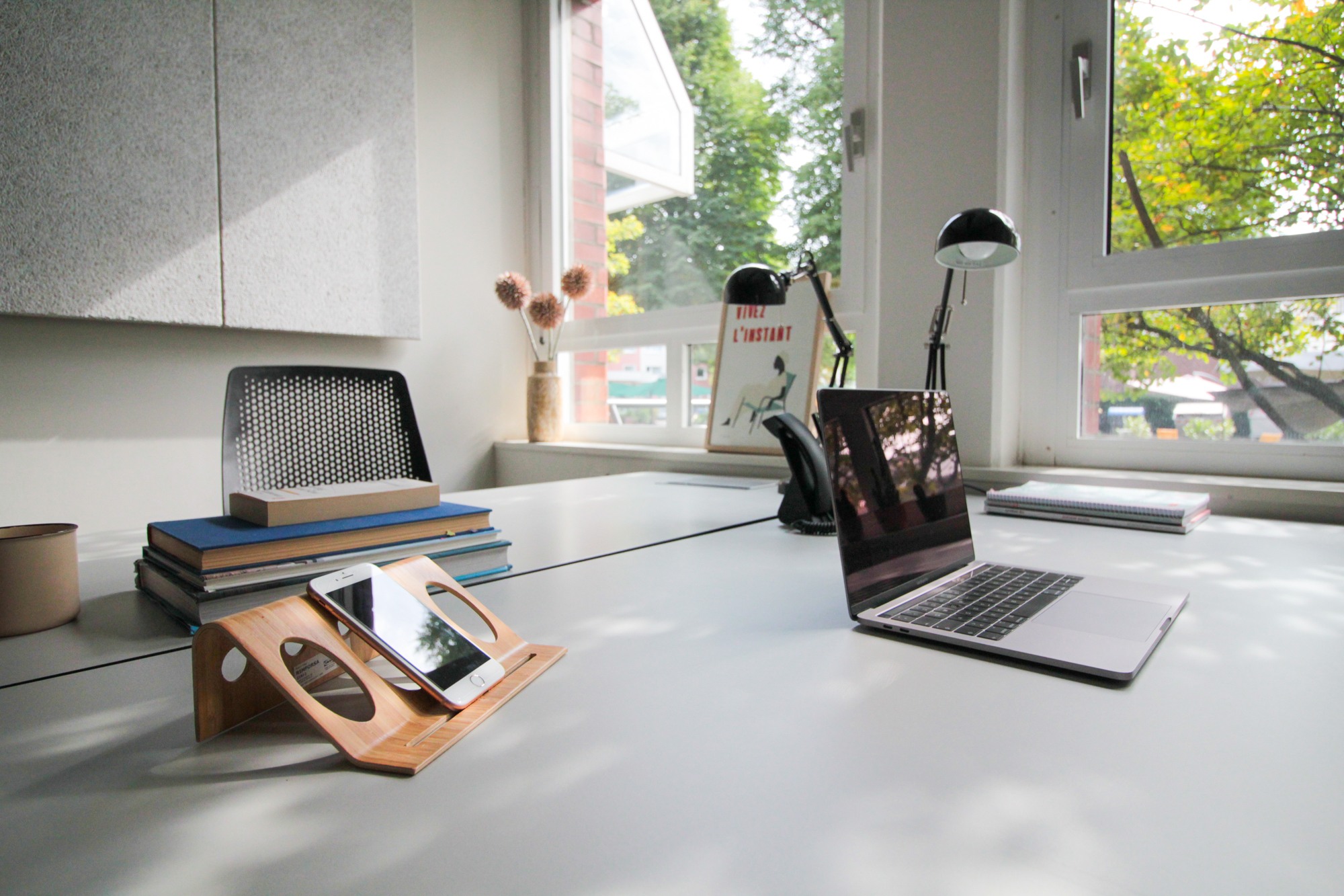 Büro mieten in Düsseldorf: Zwei Schreibtische mit einem Laptop und Blick ins Grüne